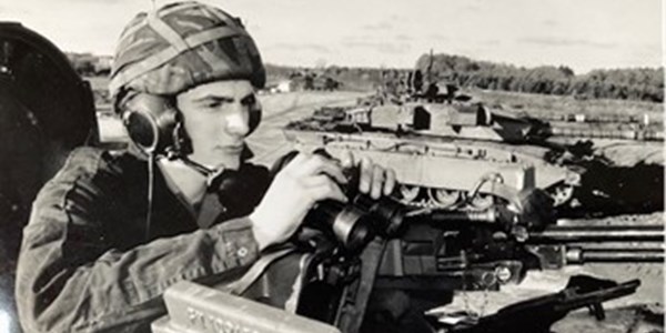 Jason Cooper in military uniform on tank