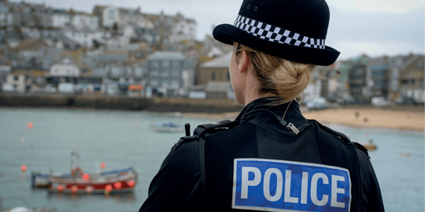 Female officer back of head looking across the bay