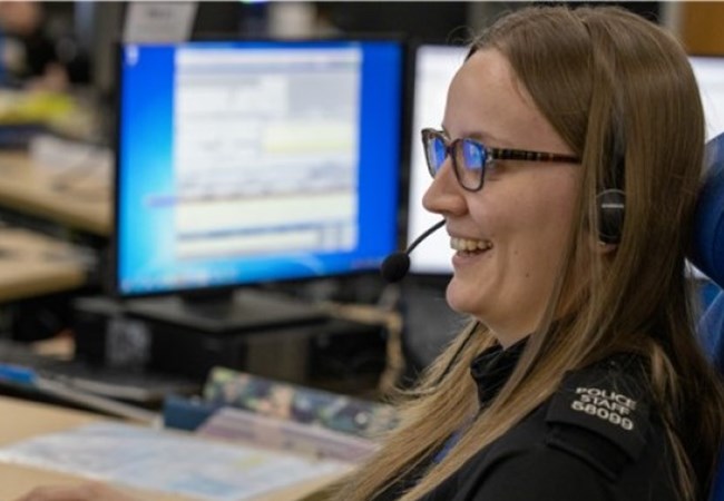 Call handler with headset looking at screen
