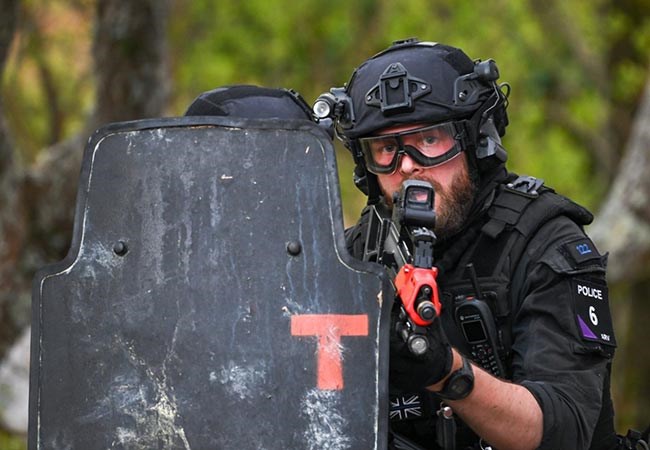 The back of an armed police officer