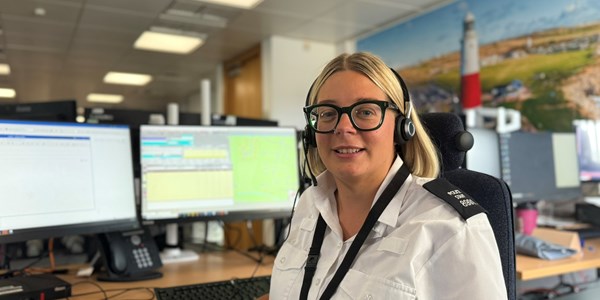 Call handler with headset looking at screen