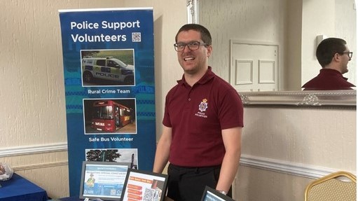 Two volunteers from behind, looking at an information board
