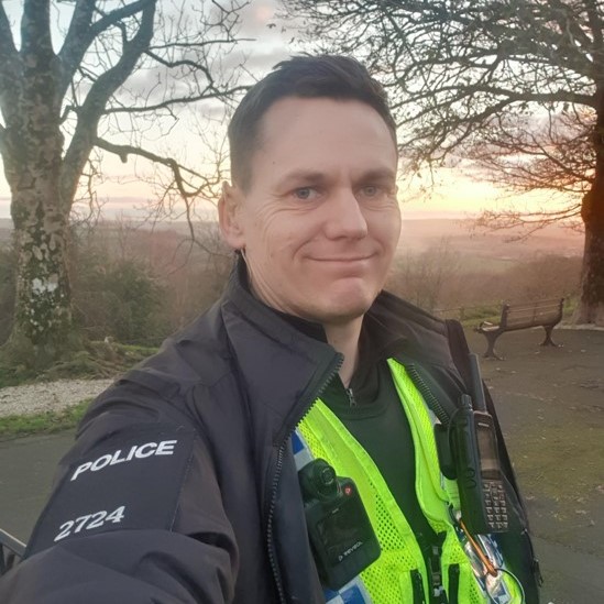 PC Matt Saunders smiling in North Dorset countryside