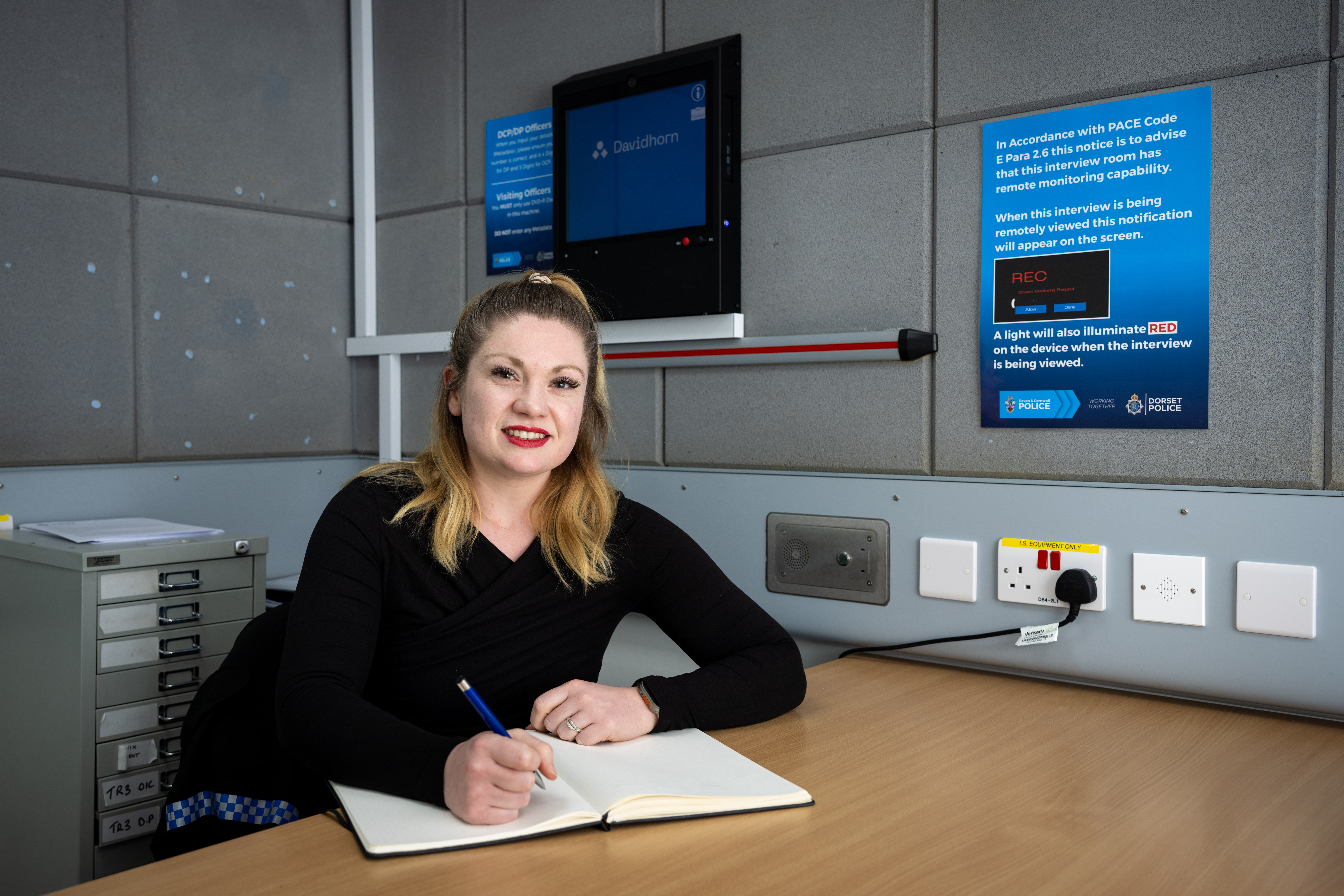 Female officer in regular office clothing at desk